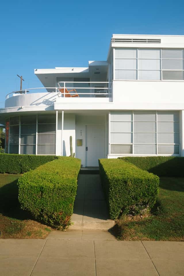 A modern commercial building and housing blueprints, representing real estate law and property development